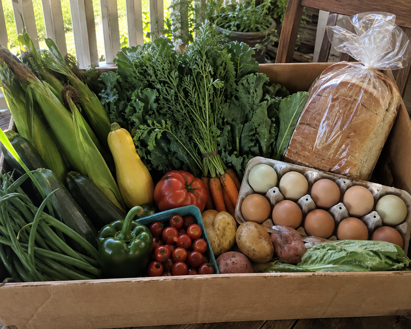 Homestead Porch Box with fresh garden produce, one dozen farm-fresh eggs, and homemade sandwich bread from Four Little Acres.