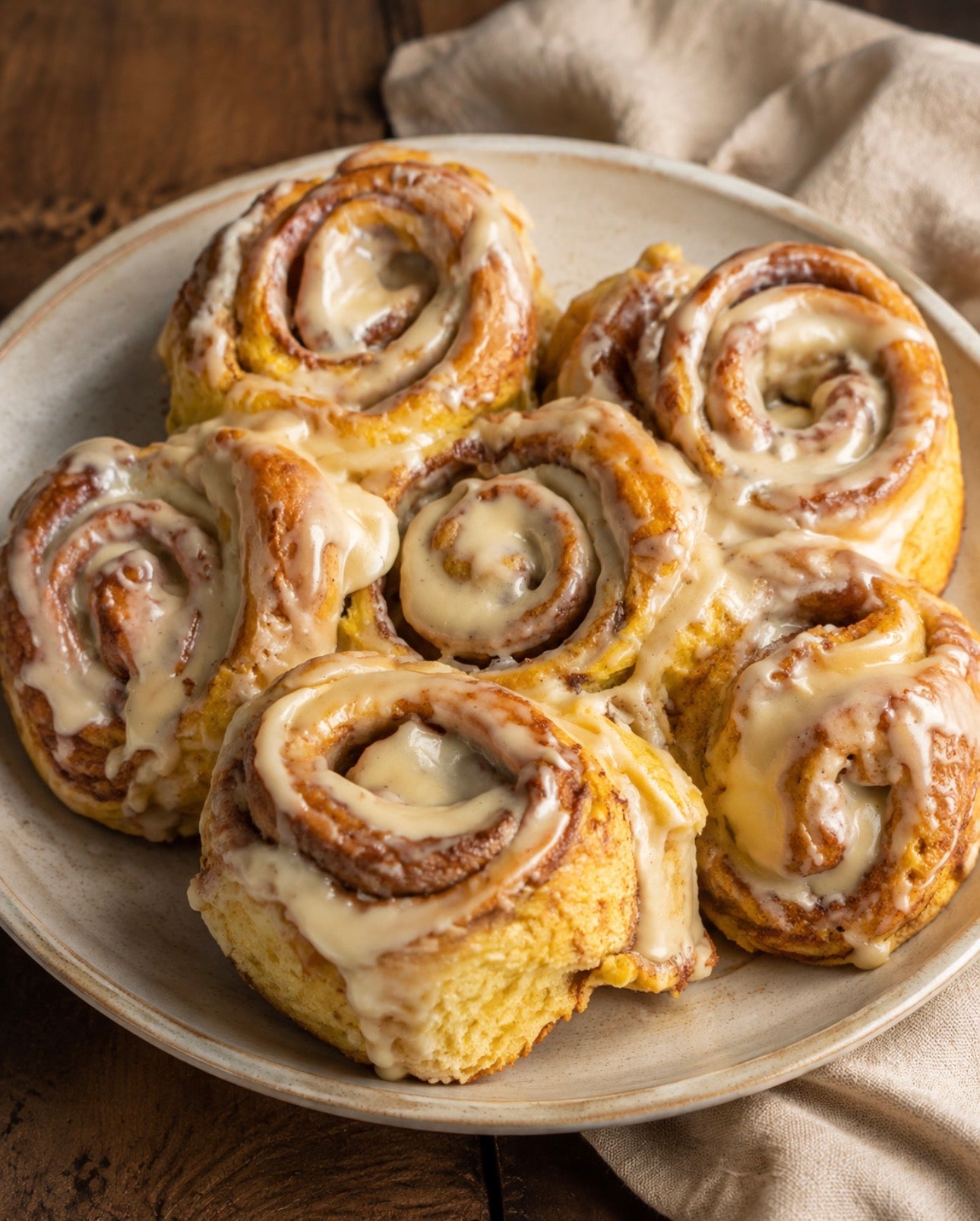Homemade Harvest Cinnamon Rolls made with garden-grown winter squash and topped with maple glaze.