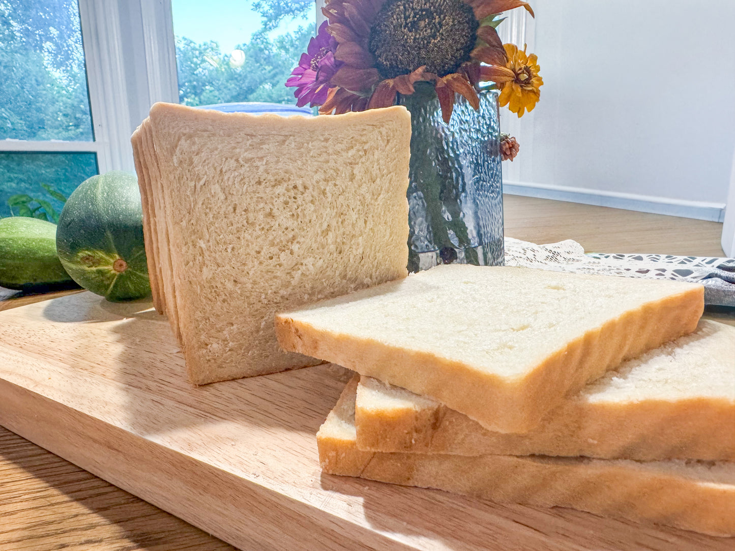 Fresh sliced homemade sandwich bread on a wooden cutting board