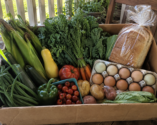 Homestead Porch Box with fresh garden produce, one dozen farm-fresh eggs, and homemade sandwich bread from Four Little Acres.